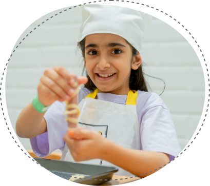 Young chef smiling during cook and bake workshop at Piccoli