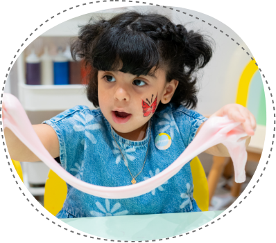 Child stretching slime during hands-on sensory workshop at Piccoli.