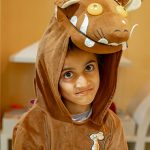 Child wearing a brown animal costume during themed play workshop at Piccoli indoor play area.
