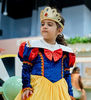 Child dressed as a princess during themed celebration at Piccoli indoor play area.
